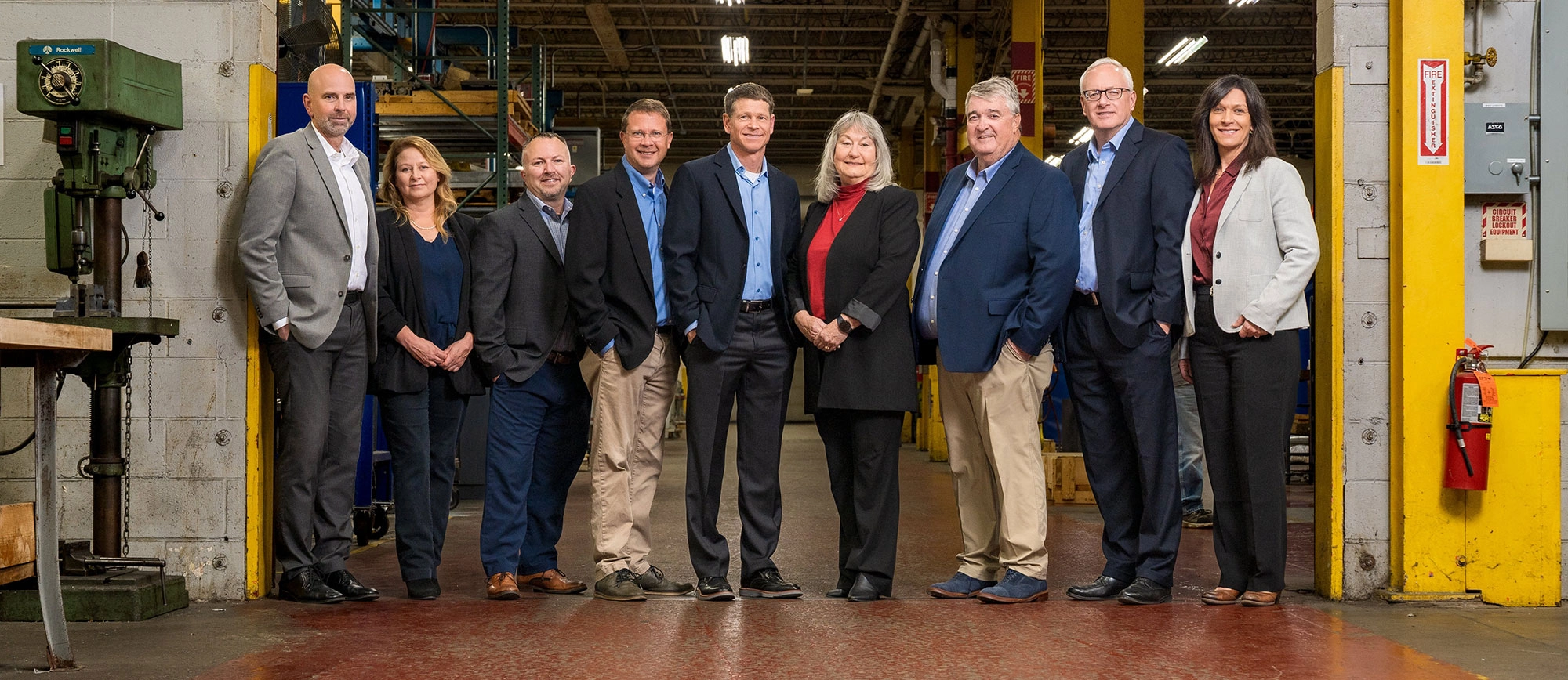 Schneider Resources team members standing together inside a manufacturing facility.